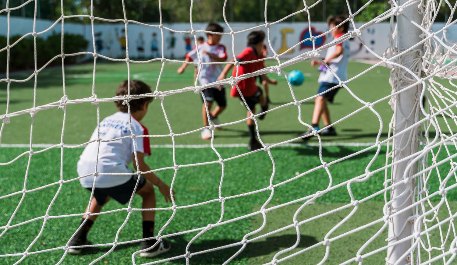 Students playing Football in School Facilities