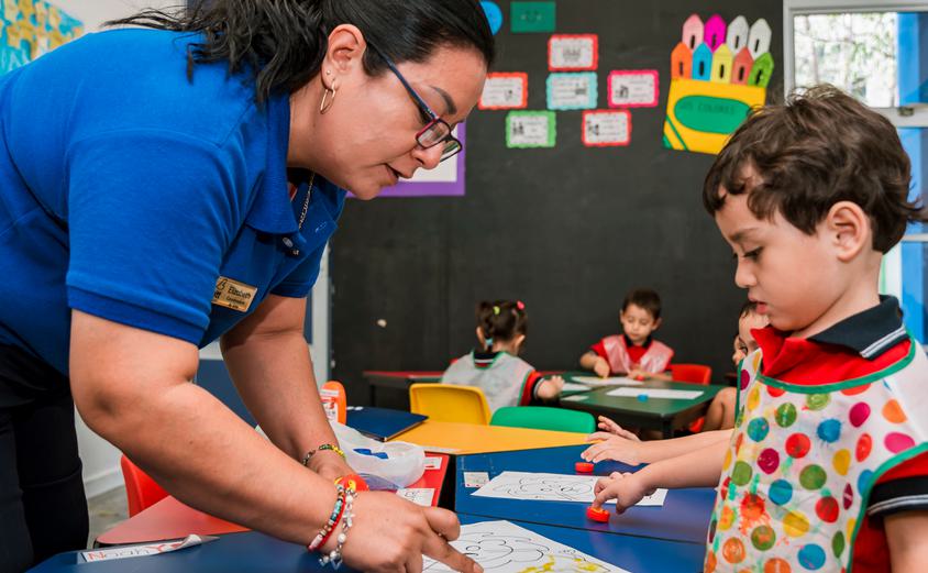 Teacher helping young student